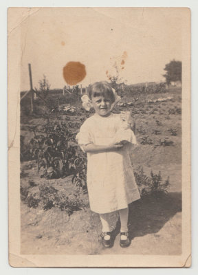 Katherine Oberg with doll in vegetable garden