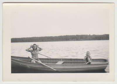 Helen Oberg and young boy in canoe on lake