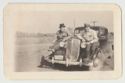 Harold Van Fleet and Paul Smith? hunting, sitting on car