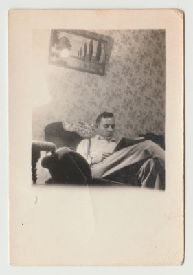 Harold Van Fleet reading on couch