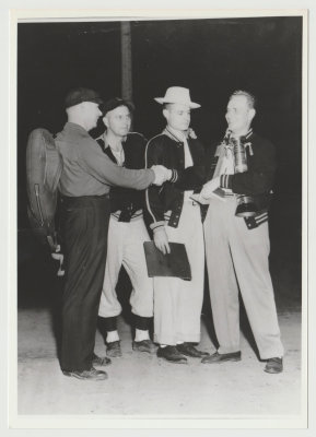Harold Van Fleet umpire with team members