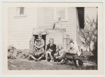 Kay Van Fleet and neighbor kids with fort in backyard