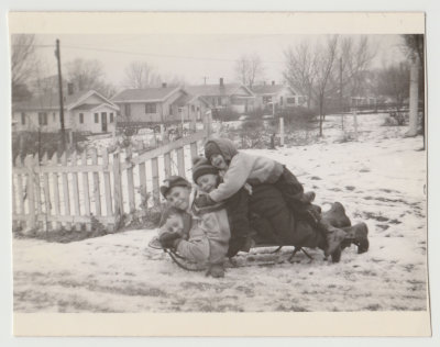 Kay Van Fleet and neighbor kids on sled
