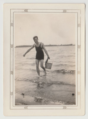 Harold Van Fleet carrying bucket in Spirit lake