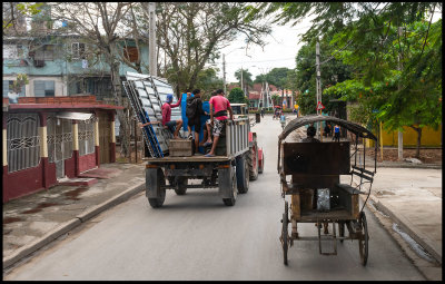 City traffic with tractor and horse cart