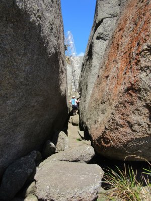 Jackie climbing up and between the huge rocks