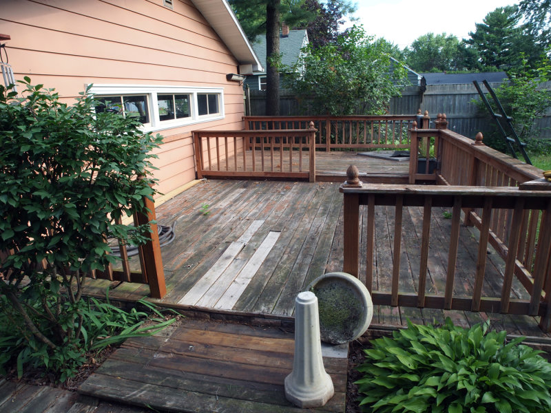 A Neglected Deck And The Rear Wall Of The Garage