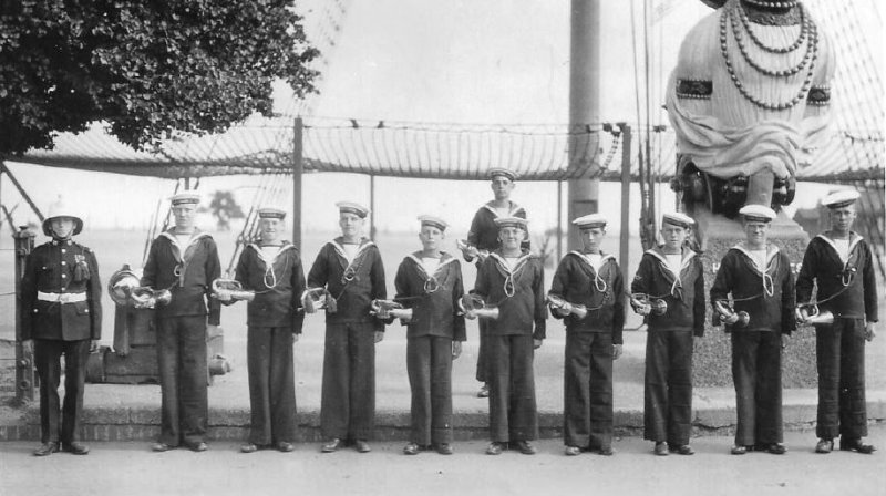 UNDATED - AN EARLY PHOTO OF BOY BUGLERS UNDER THE MAST WITH THEIR INSTRUCTOR.JPG