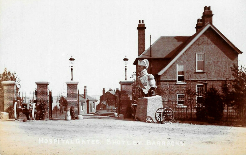 UNDATED - EARLY PHOTO OF THE SICK BAY GATES, TRAFALGAR FIGURE HEAD IN FRONT OF THE SISTERS QUARTERS. NOTE THE MILK CHURN