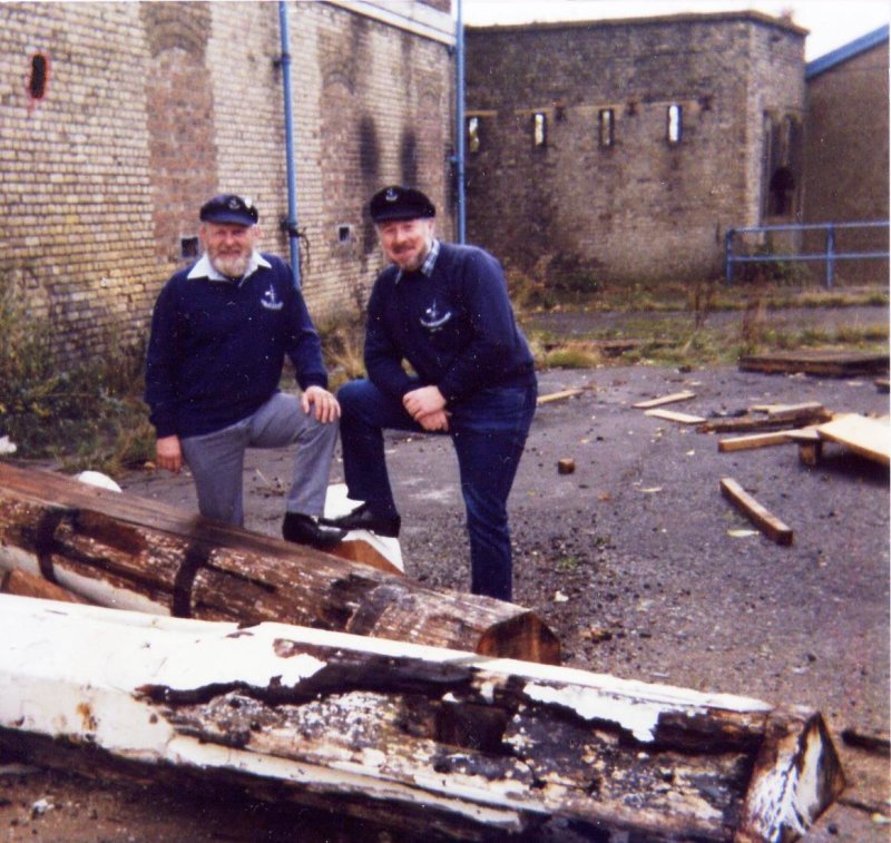 1988 - DICKIE DOYLE AND GEOFF HILL SURVEYING THE ROT TO THE MAST OUTSIDE THE OLD GENERATOR SHED.jpg