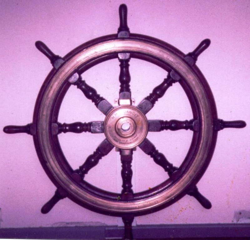UNDATED - DICKIE DOYLE, WHEEL FROM HMS GANGES II, IN THE OFFICE OF MIDLAND IRON AND STEEL, NETHERTON.jpg