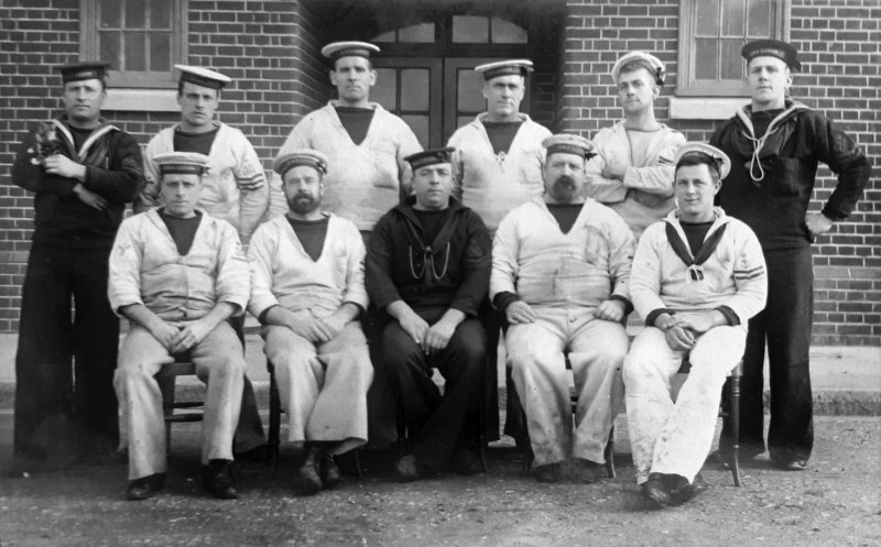 1914c - GROUP OF POSSIBLE INSTRUCTORS, NOTE ONE ON LEFT HOLDING A KITTEN..jpg