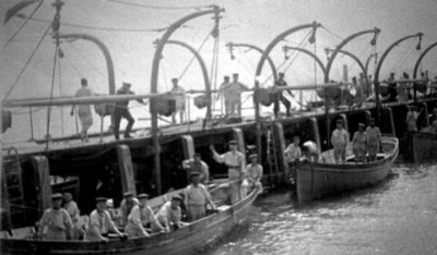 UNDATED - BOYS IN CUTTERS ALONGSIDE THE PIER.jpg