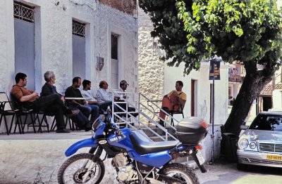 Greece, Peloponnese; people at the bar in a small village. 