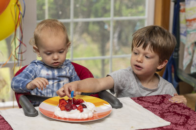 Big brother gets the candle out of the way