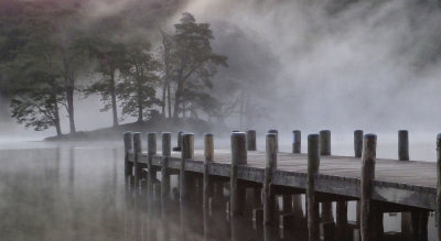 Morning mist over Coniston Water and Lake Bank Pier