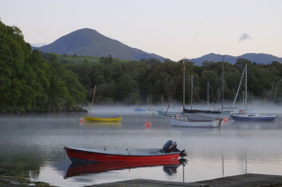 Morning mist over Coniston Water with Old Man of Coniston