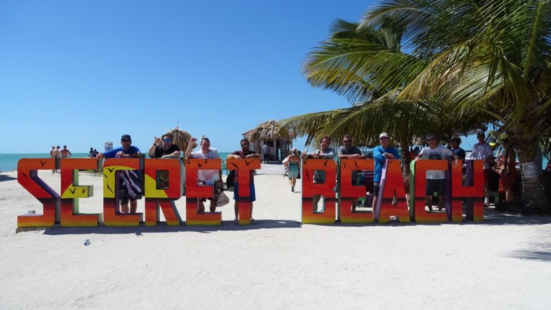 Secret Beach Sign with all the gang