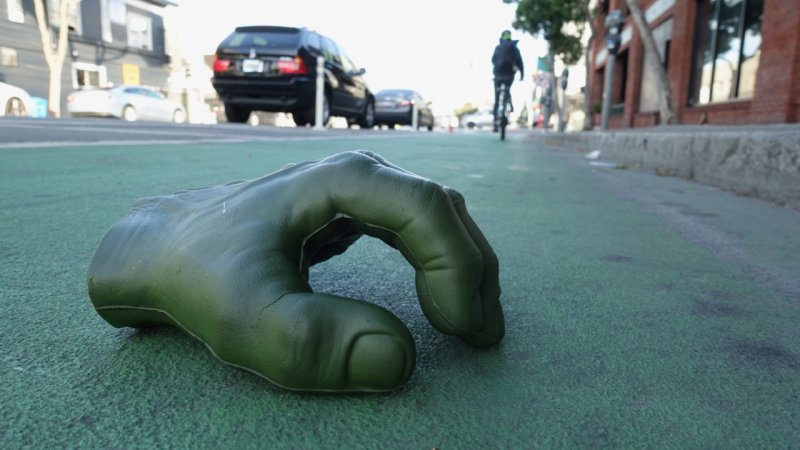 Big Green hand in a green bike lane