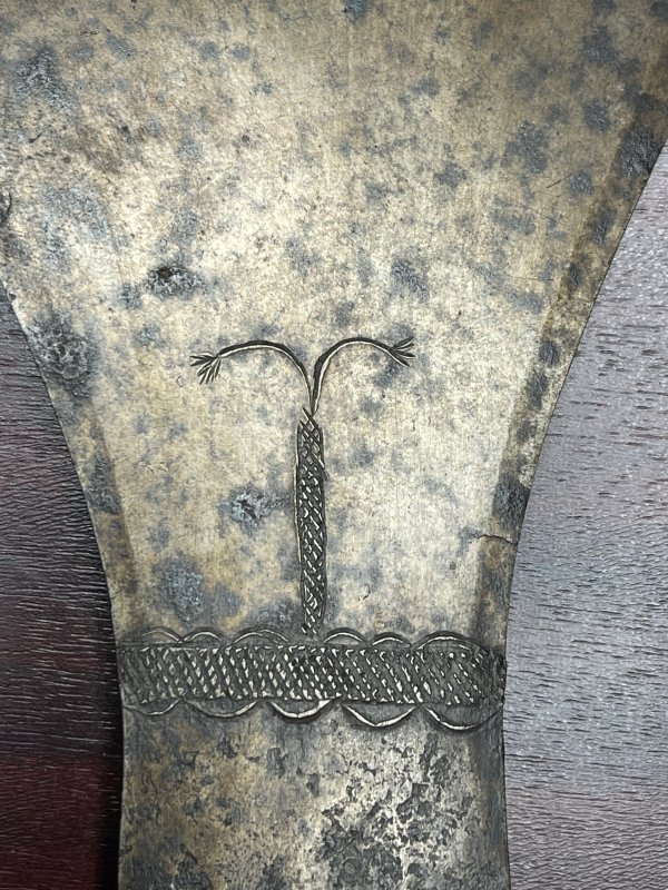 Ornament on the blade of a Fang axe.