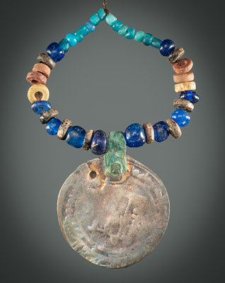 Viking Age necklace from the Ladoga area, eastern trade route, silver dirham, blue glass and Baltic amber beads.
