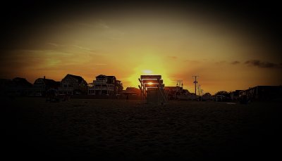 Sunset setting lifeguard stand on fire