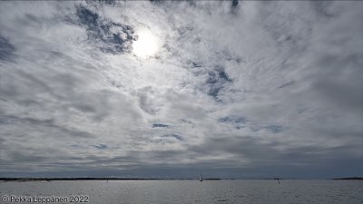 Boat and sun through clouds
