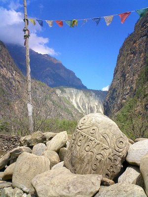 Prayer flags and stone.