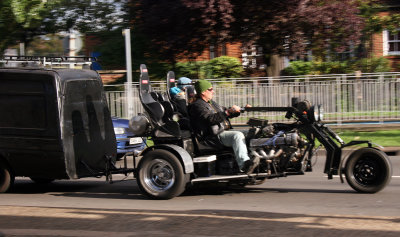 A 3 seater V8 trike towing half a car. Dont see that every day.