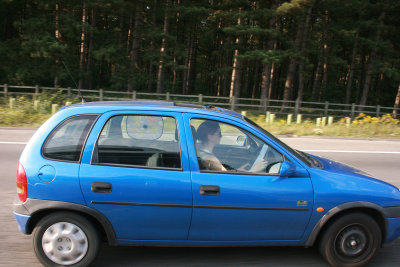 Reading some papers at a steady 70 mph on a busy motorway.