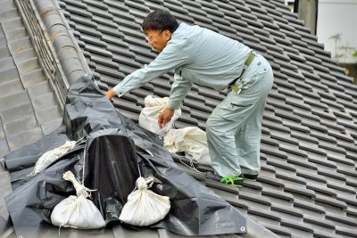 Repairing The Landlord's Roof After The Typhoon