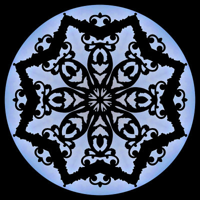 Kaleidoscopic picture created with an iron gate and blue sky