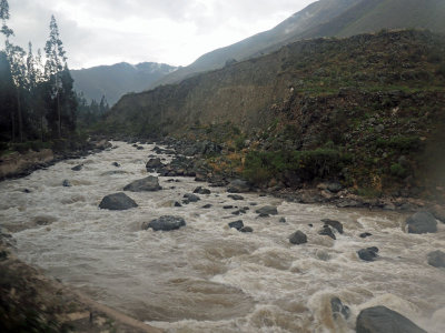 The Urubamba river flows next to the train tracks to Machu Picchu