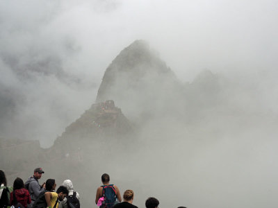 The Intihuana at Machu Picchu begins to appear through the clouds