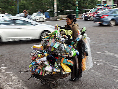 Heavily post-processed picture of a vendor moving her wares