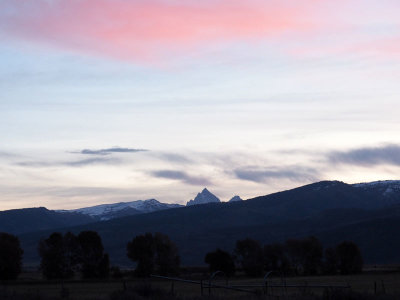 The top of the Teton Mountains in the distance at sunrise
