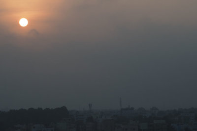 Sun rising above the early morning layer of smog