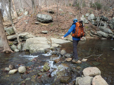 Crossing a stream near a waterfall