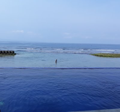 Pool and sea. Bali Santi Bungalows. Candi Dasa