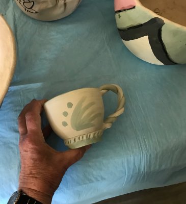 thrown cup with green and white clay twisted handle