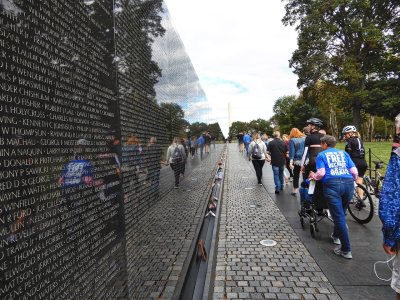 One side of the Vietnam Memorial Wall points directly to the Washington Monument, the other to the Lincoln Memorial