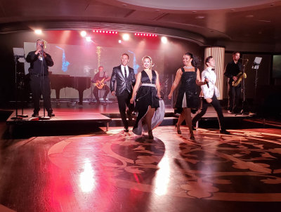 The Azamara Pursuit Band and the Signature Singers performing in the Cabaret