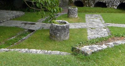 Pieces of 15th Century aqueduct used as planters at Izletiste Mill in the Konavle Valley, Croatia