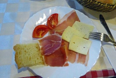 Mid-morning snack of Njeguski prsut (local prosciutto), local cheese, fresh tomatoes, and homemade bread