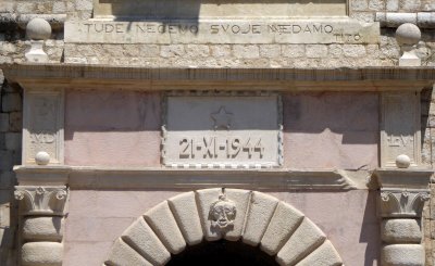 Inscription above the Sea Gate acknowledges the date of the end of WWII in Montenegro