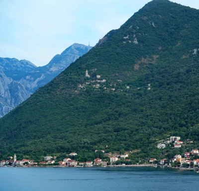 Looking at a hillside town on the Bay of Kotor from Aqualina Restaurant on the Azamara Pursuit