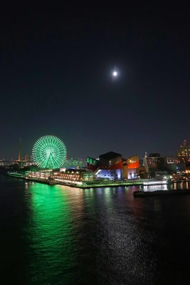 Sailing away from Osaka, Japan under a bright moon