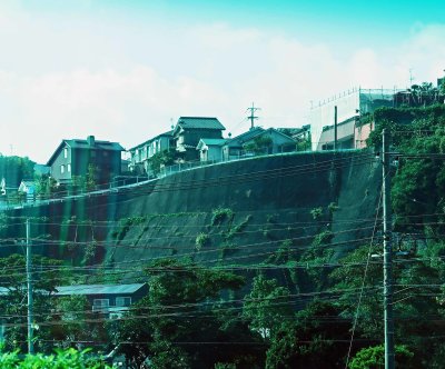 Houses above a retaining wall in Kagoshima, Japan