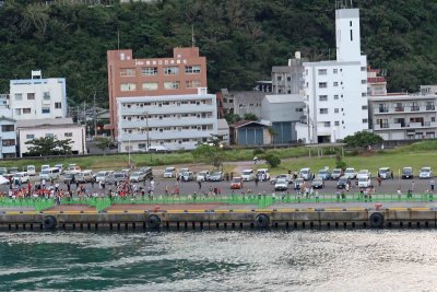 People waiving goodbye from Amami Island, Japan