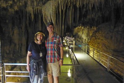 In front of 'gathered drapes' stalagtites in Gyokusendo Cave
